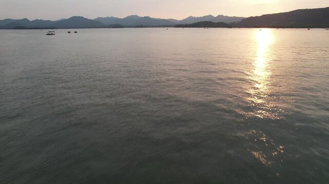 Golden sunset over the calm water of West Lake in Hangzhou China