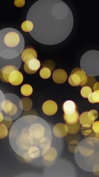Golden bokeh lights animation over dark background