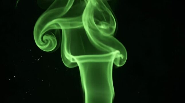 Green smoke swirling against black background