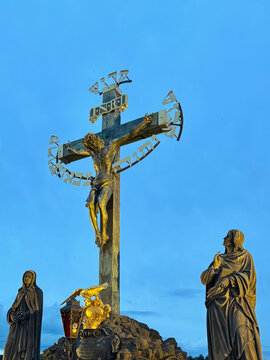 Bronze statues of calvary scene at Charles Bridge in Prague, Czechia