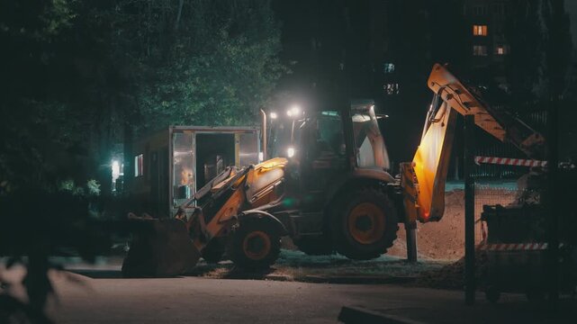 Backhoe Loader Digging Trench at Night | Excavator Arm Lifting Bucket for Water Pipe Installation | Urban Street Construction Site with Headlights