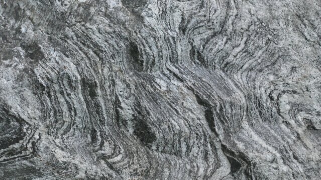Gray Natural Stone Surface with Layered Wavy Patterns