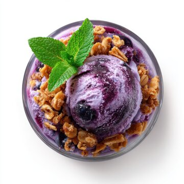 Blueberry parfait ice cream with granola and mint leaf topping isolated on a white background