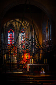 Interior of the Minster of St. Mary and St. Mark at Reichenau Abbey with Stained Glass and Solitary Worshipper
