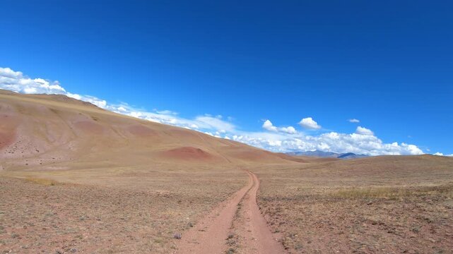 Driving along a country road in Altai desert and semi-desert environment.