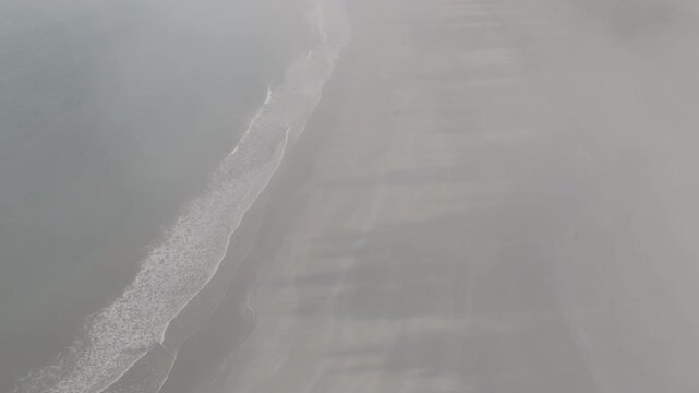  Aerial view flying through fog to sandy beach with ocean waves of Washington coast , ocean waves of Olympic Peninsula (D-log / Ungraded version)