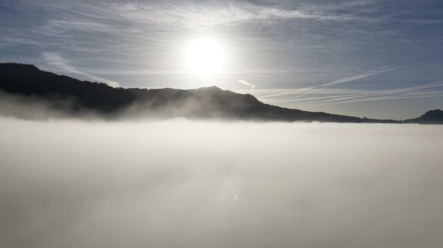 Drone footage with low level sun over the mist in Switzerland. Shot on DJI Mavic Air 3s 4K 60fps 150mbit.