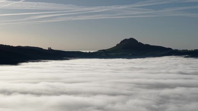 Hills over the mist at sunny day in Switzerland. Shot on DJI Mavic Air 3s 4k 60fps 150mbit.