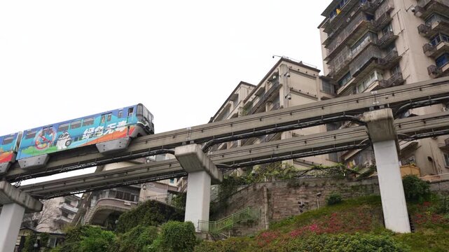 Monorail entering a building at Liziba Station in Chongqing China during a cloudy day