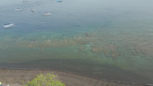 Tourists Swimming In Tropical Jemeluk Bay Amed Bali Indonsia Drone Track In 4K 60FPS