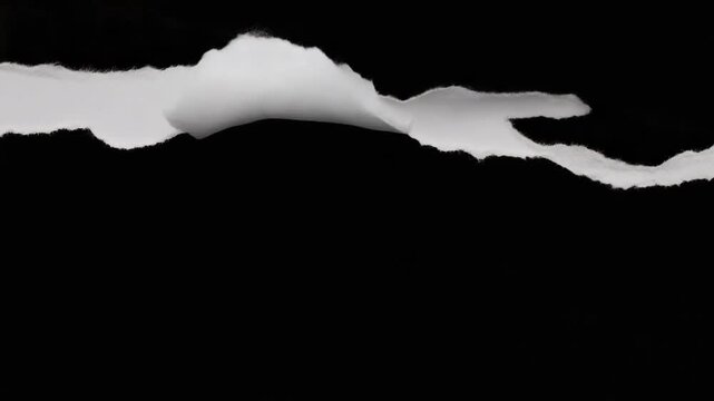 White paper tearing transition revealing black background for video editing