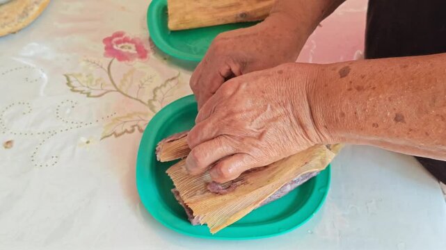 Serving Fresh Hot Red Tamales onto Dining Plate