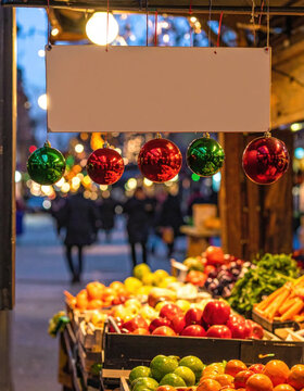 Christmas ornament market stall fresh produce festive display colorful decoration hanging sign