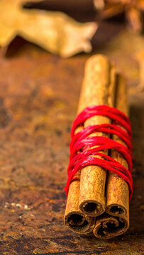 Cinnamon stick bundle red thread rustic surface warm concept