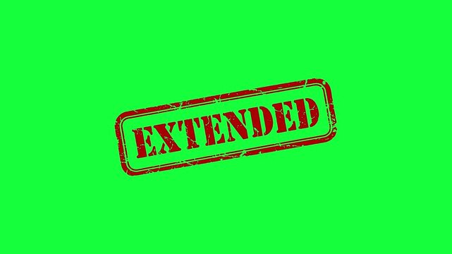 Red extended deadline rubber stamp imprint on bright green background for time management