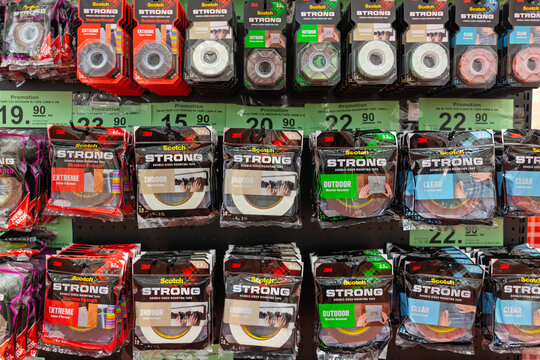 Penang, Malaysia - Aug 08, 2026: Various types of 3M Scotch Strong double-sided mounting tapes, including Extreme, Indoor, Outdoor, and Clear varieties, hanging on retail hooks in a hardware store in 