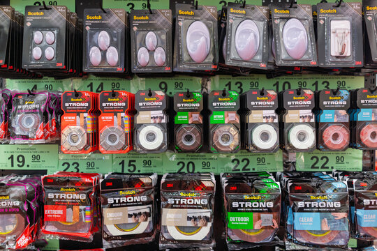 Penang, Malaysia - Aug 08, 2026: Various 3M Scotch products including permanent adhesive hooks and double-sided mounting tapes displayed on retail racks in a store in Penang.