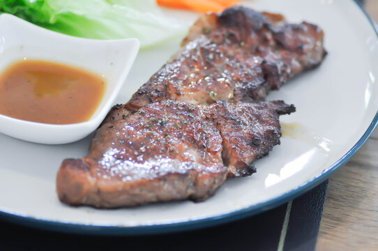 pork steak or grilled pork and salad or pork chop and vegetable