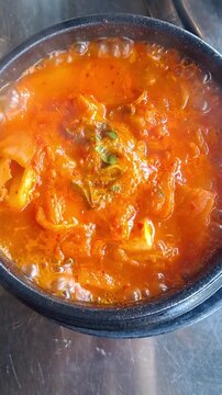 Traditional Korean Kimchi stew in a hot earthenware pot (Ttukbaegi kimchi jjigae) - Traditional Korean food