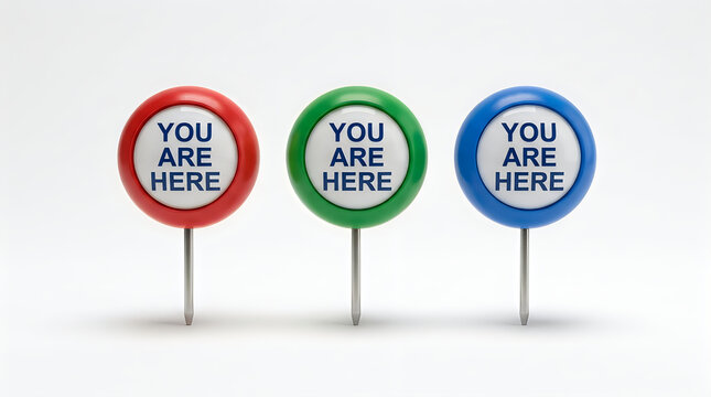Three colorful map pins with you are here text