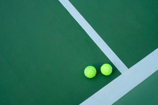 Green Tennis Balls on Green Hard Court Near White Boundary Lines, Overhead View