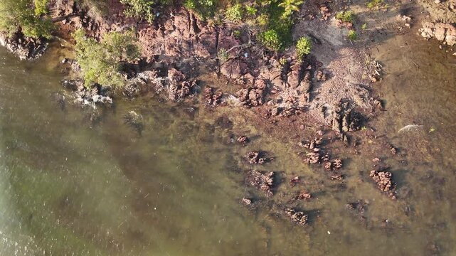 Aerial Shot of Rocky Coastline with Clear Water in Batam, Indonesia - 4K