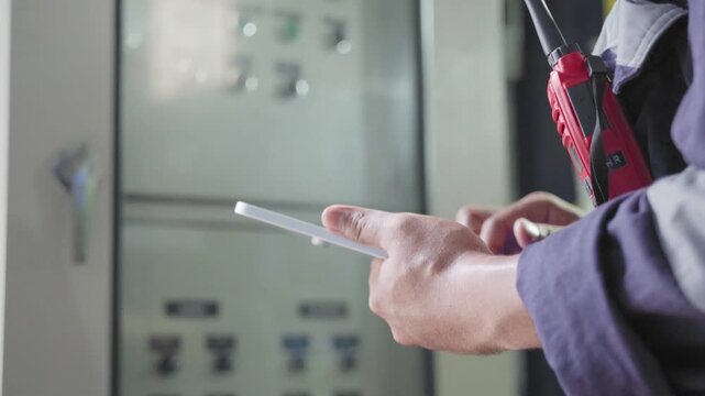 Electrical engineers are checking the maintenance systems of machinery in industrial plant. Professional engineering using digital tablet taking note report during work. Factory industry