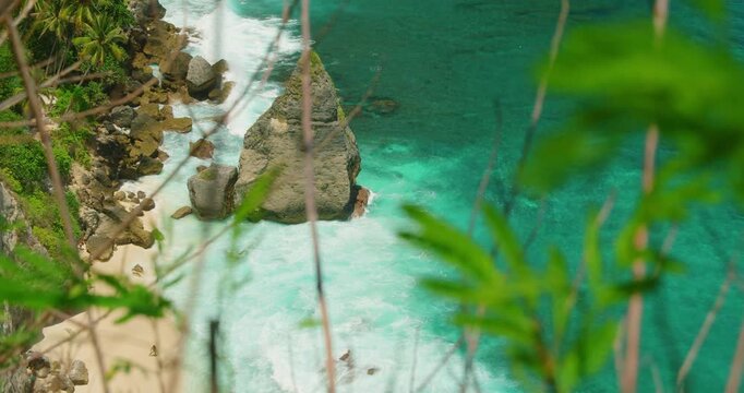 High angle view of turquoise sea water splashing against limestone rock formation at Diamond beach Nusa Penida Bali Island Indonesia