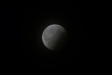 A close-up of a partial lunar eclipse against a black-night sky. © Misty