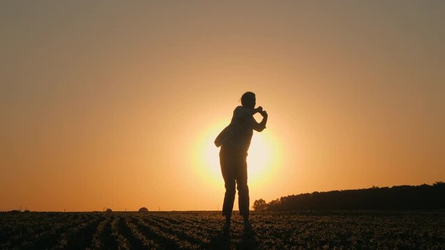 Farmer Dancing With Raised Hands in Sunset Field
