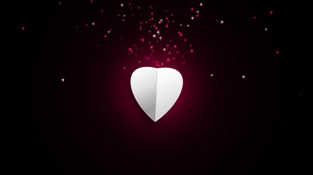 White paper heart opening revealing pink glitter particles floating upwards 