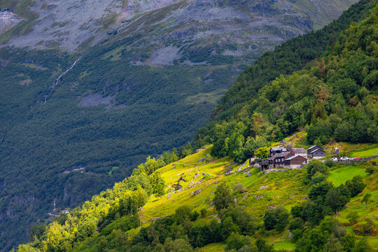 A beautiful traditional mountain farm buildings high on the mountain at the Geiranger village. A summer scenery of World Heritage area in Western Norway.