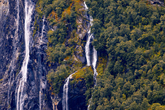 A beautiful waterfalls over the cliffs in the Geiranger village. A summer scenery of World Heritage area in Western Norway.