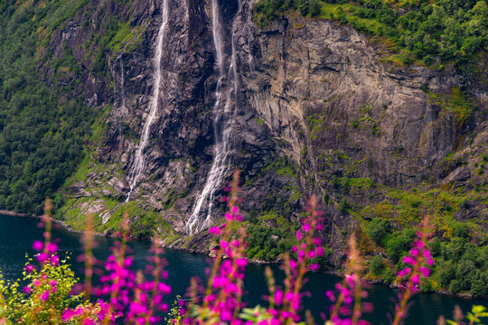 A beautiful waterfalls over the cliffs in the Geiranger village. A summer scenery of World Heritage area in Western Norway.