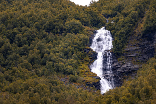 A beautiful waterfalls over the cliffs in the Geiranger village. A summer scenery of World Heritage area in Western Norway.