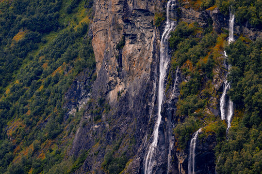 A beautiful waterfalls over the cliffs in the Geiranger village. A summer scenery of World Heritage area in Western Norway.