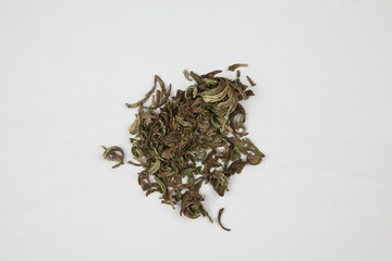 Dried Medicinal Herb Leaves on White Background © KieuLan