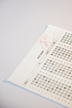 Education and assessment concept, teacher grading student exam with top mark.