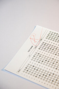 Education and assessment concept, teacher grading student exam with top mark.