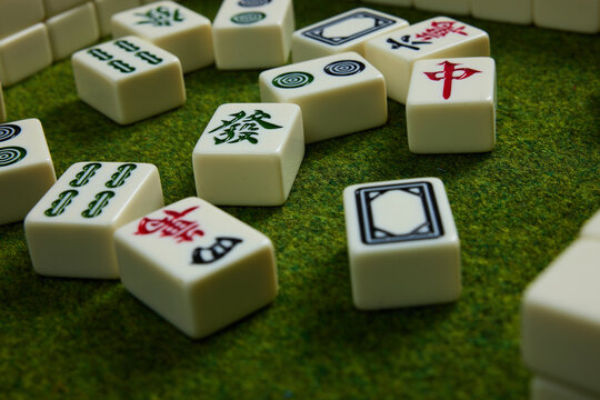Mahjong Tiles on Green Felt Table