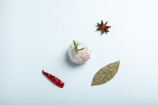 Garlic and Spice Ingredients on Light Blue Background