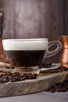 Cappuccino is an espresso-based coffee drink and steamed milk foam made from coffee in a transparent glass cup. Hot coffee with steam.