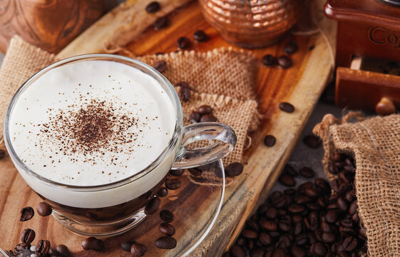 Cappuccino is an espresso-based coffee drink and steamed milk foam made from coffee in a transparent glass cup.