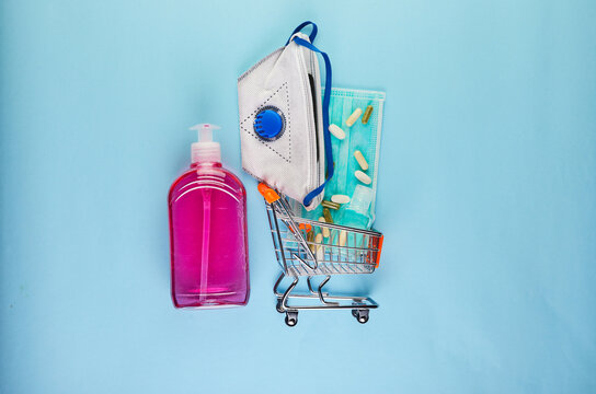 The concept of the outbreak of coronavirus COVID-19, How to protect yourself from infection. Cart with protective goods. Wash your hands, wear a protective mask, pills, hand sanitizer,gel. Copy space.
