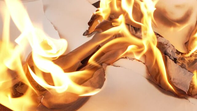 paper burning with bright yellow flames