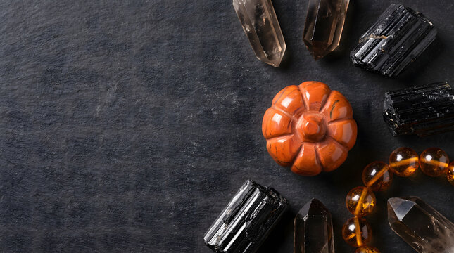 Halloween Crystal Altar Flat Lay with Jasper Pumpkin, Smoky Quartz Points, Black Tourmaline and Amber Beads on Slate