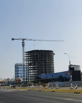 BREST, BELARUS - JULY 15, 2023: Construction site of a modern multi-story concrete building with a high tower crane