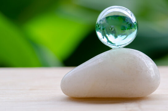 Crystal sphere on zen stone representing focus and mindful awareness, with customizable space for text.