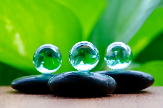 Marbles and zen stones in nature representing serenity and peaceful connection, with customizable space for text.