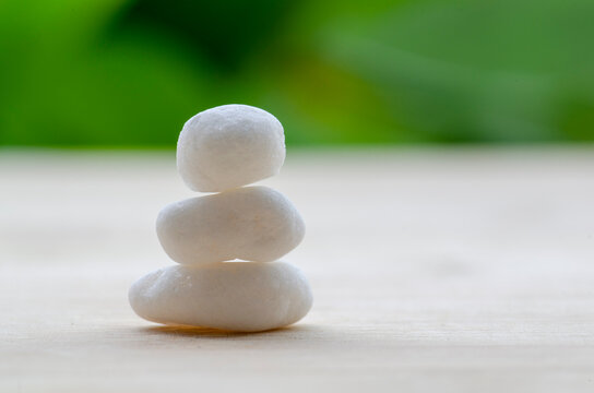 Minimal white zen stones representing harmony and spiritual balance, with customizable space for text.